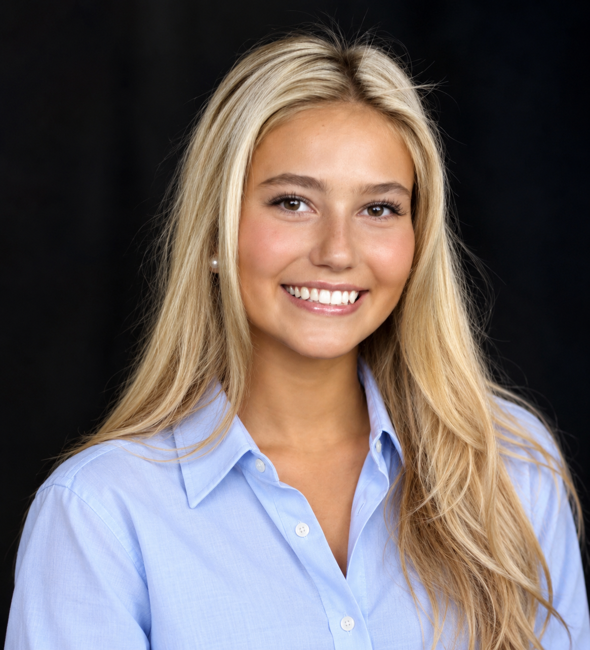 Cally Kammerer smiling in a light blue button-down shirt